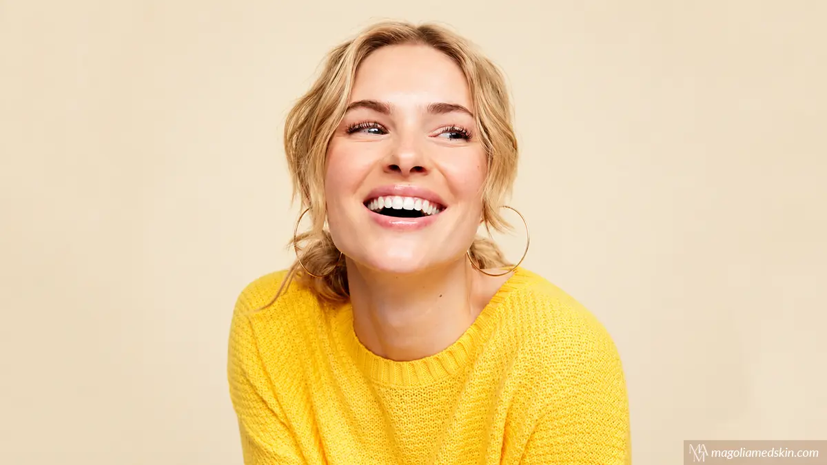 Happy woman wearing yellow sweater after vitamin B12 deficiency symptoms injection relief