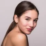 Beautiful woman with glowing skin, naturally full lips, and defined facial contours, illustrating how long do dermal fillers last in different treatment areas