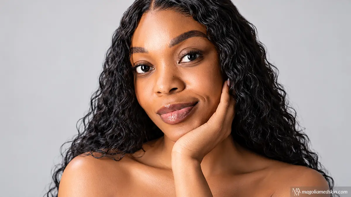 Beautiful woman with radiant, smooth skin representing the benefits of microneedling vs chemical peel treatments at Magnolia Medical & Aesthetics in San Antonio, TX.